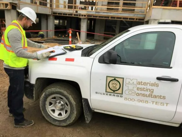 an mtc employee working next to a company truck